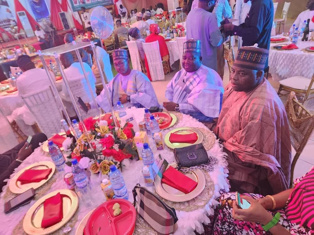 Guests seated at a dinner table during a company event