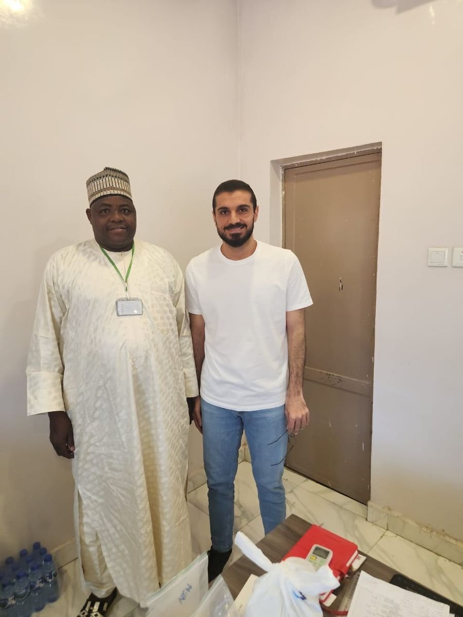 Company representative standing with a visitor in an office