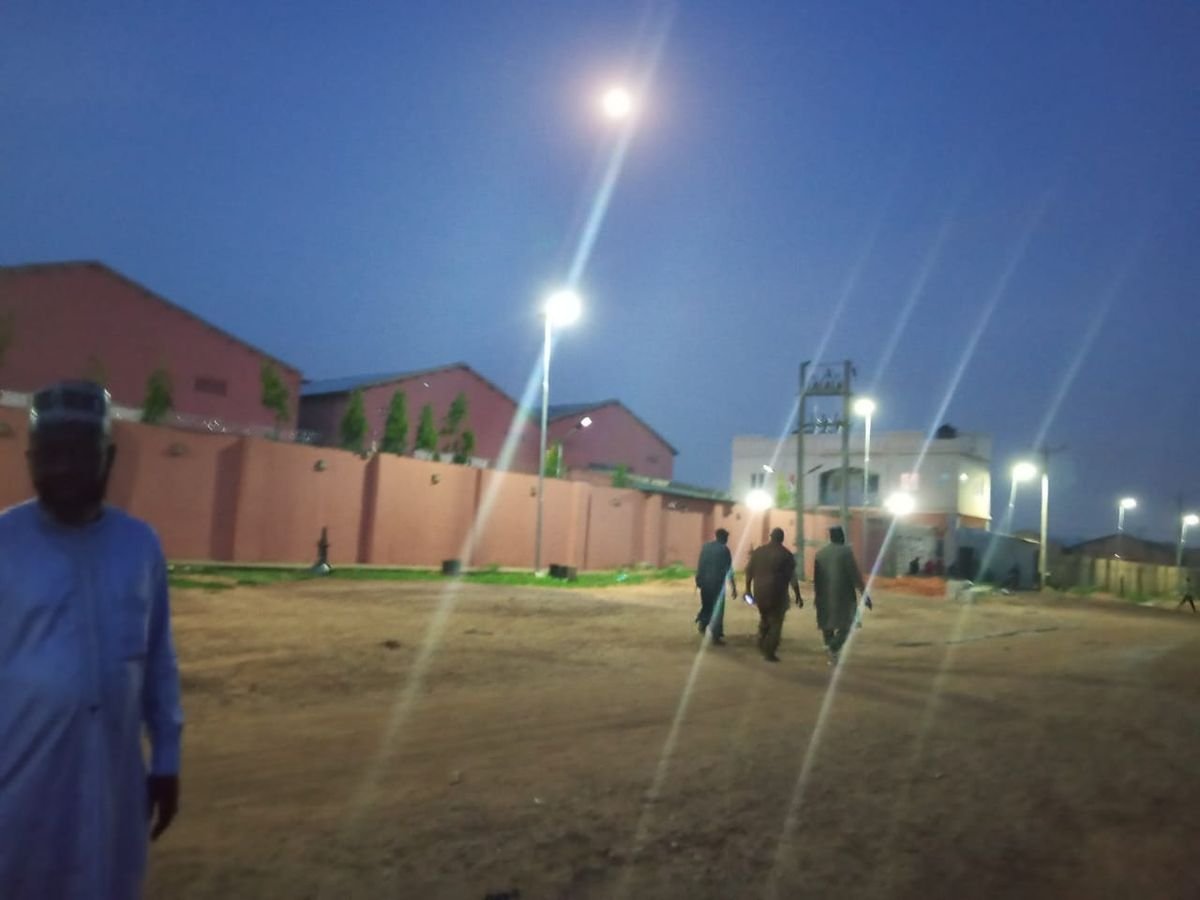 Warehouse compound and loading yard at dusk under floodlights